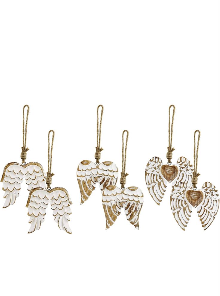 four angel ornaments hanging from strings on a white background, each with an ornament in the shape of two wings