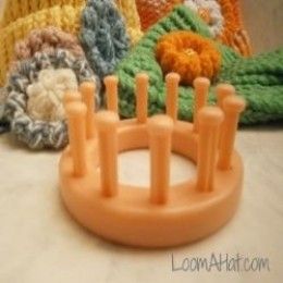 several crocheted hats sitting next to each other on top of a white table