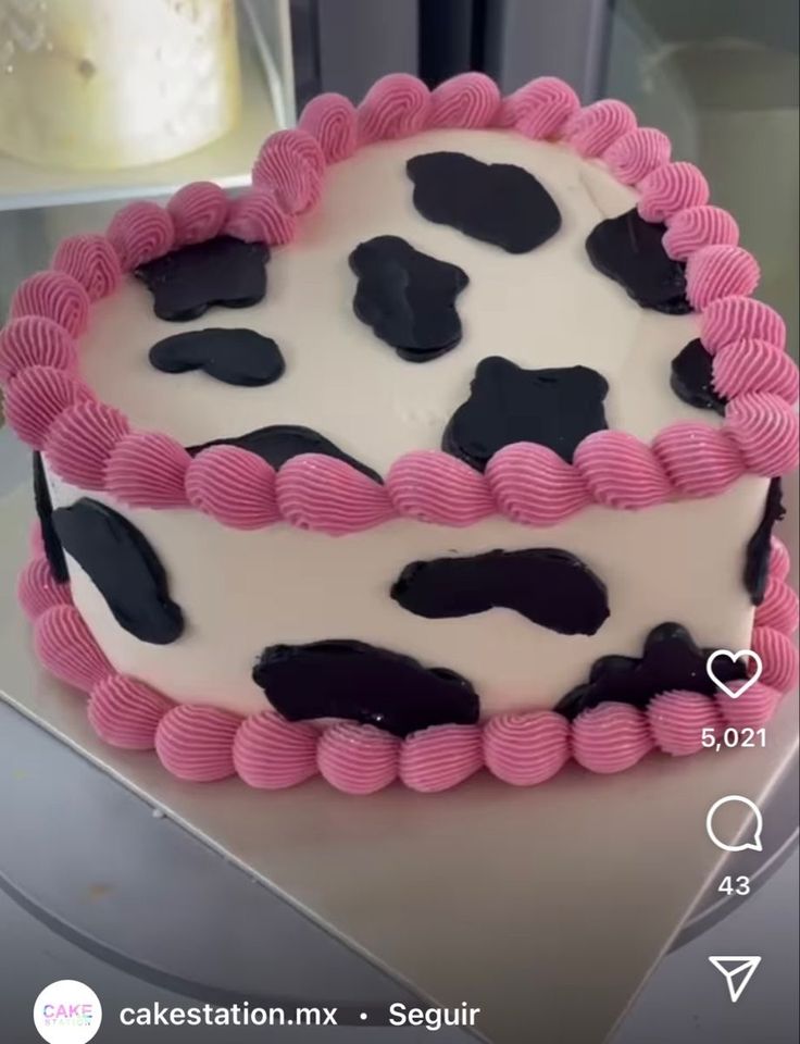 a cake decorated with pink and black icing