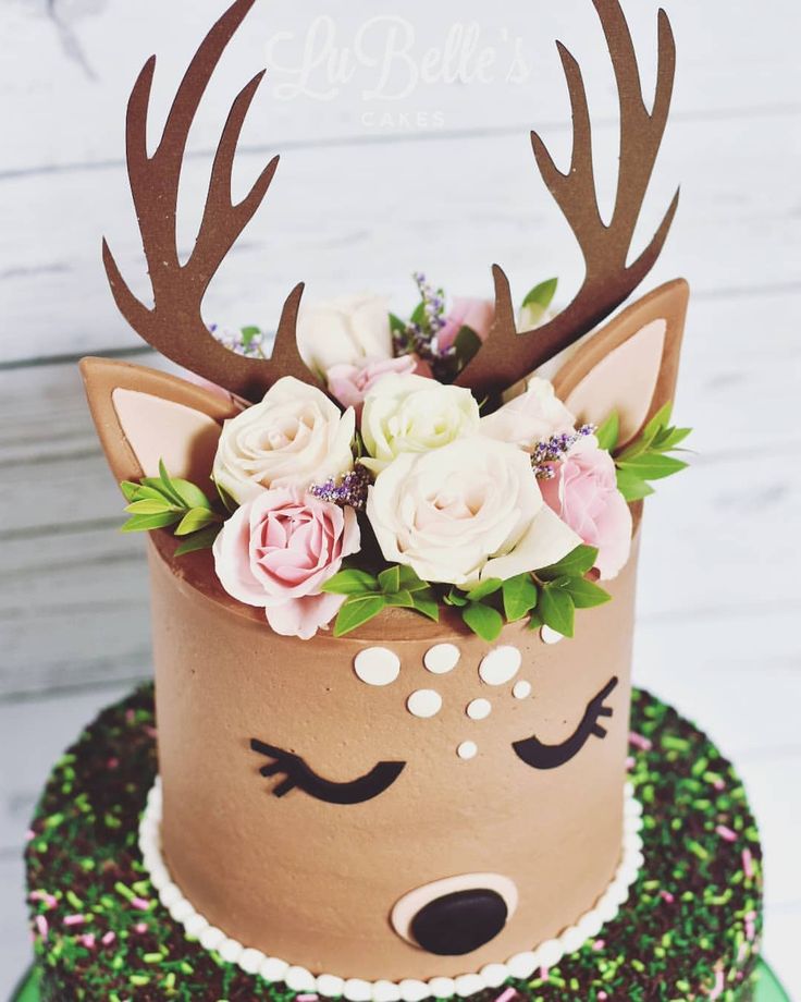 there is a cake decorated with flowers and deer horns