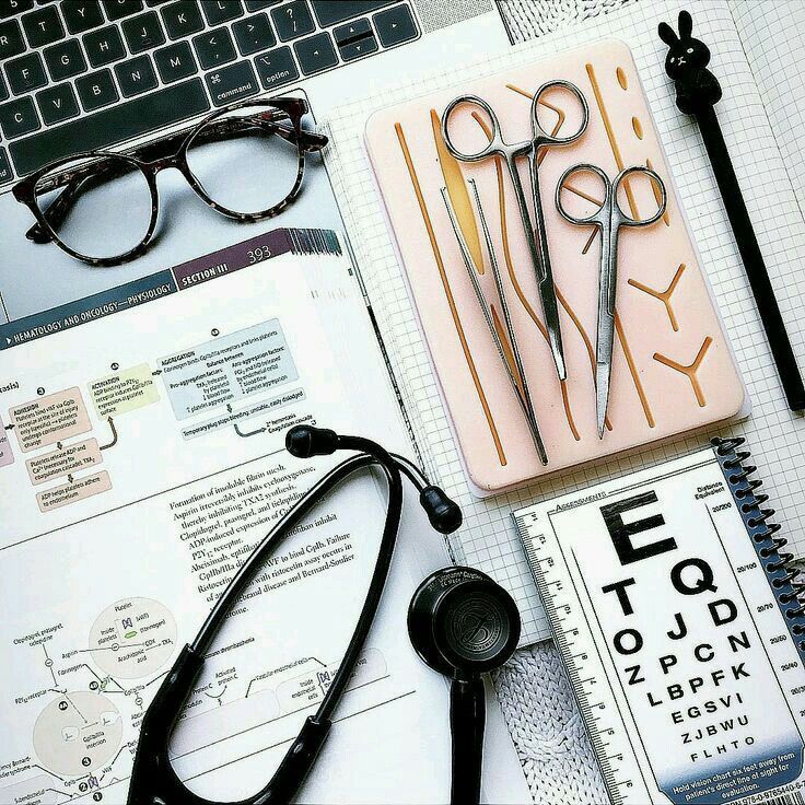 a pair of scissors sitting on top of an open notebook next to eyeglasses