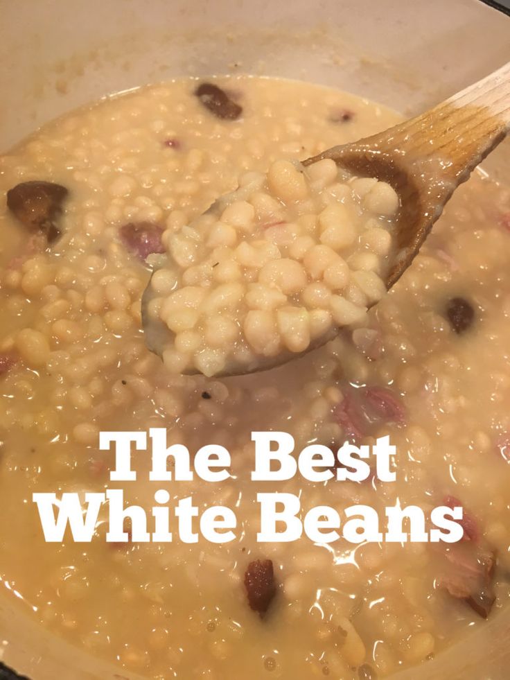 the best white beans recipe is being stirred with a wooden spoon