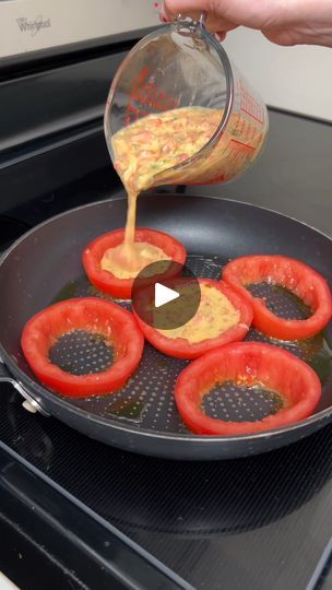 someone is pouring dressing on tomatoes in a frying pan over an open stove top