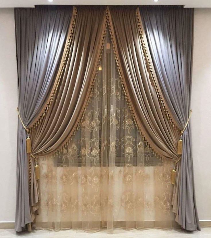 the curtains are open and ready to be hung in front of the window with gold trim