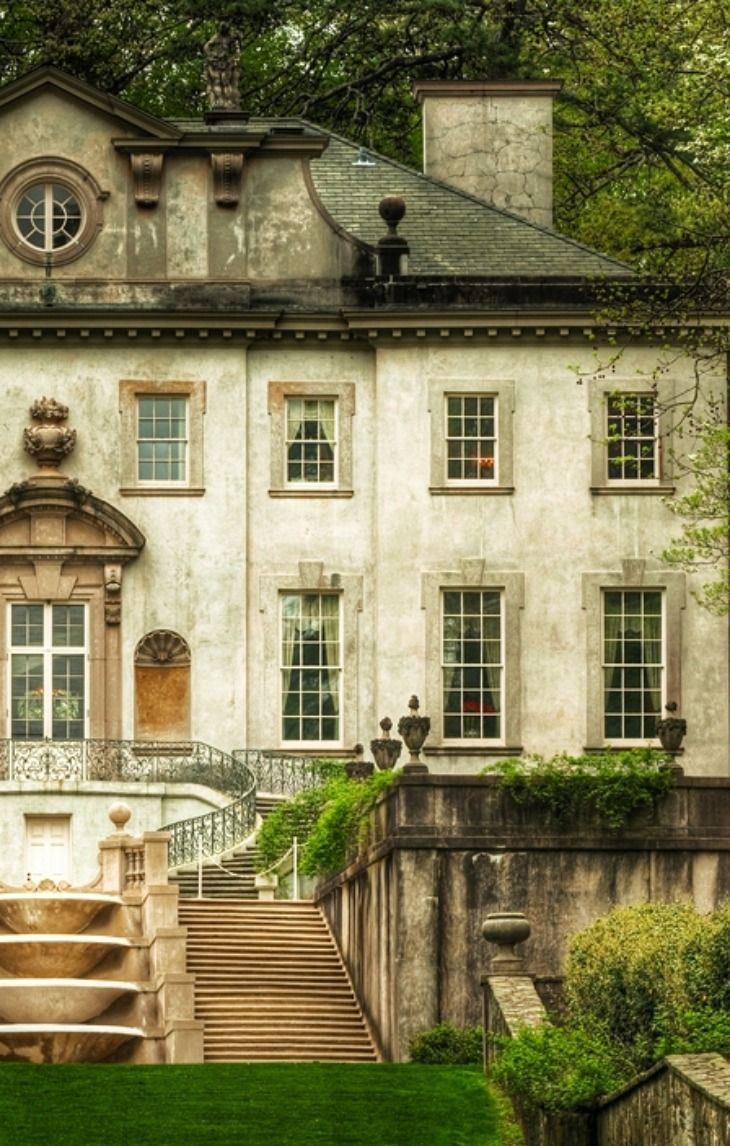 an old mansion with steps leading up to it