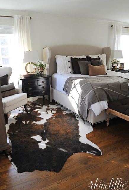 a bedroom with a cow hide rug on the floor