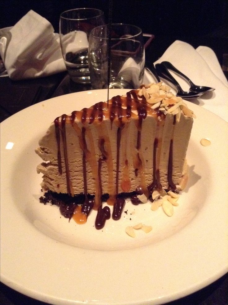 a piece of cake on a plate with chocolate sauce drizzled over it