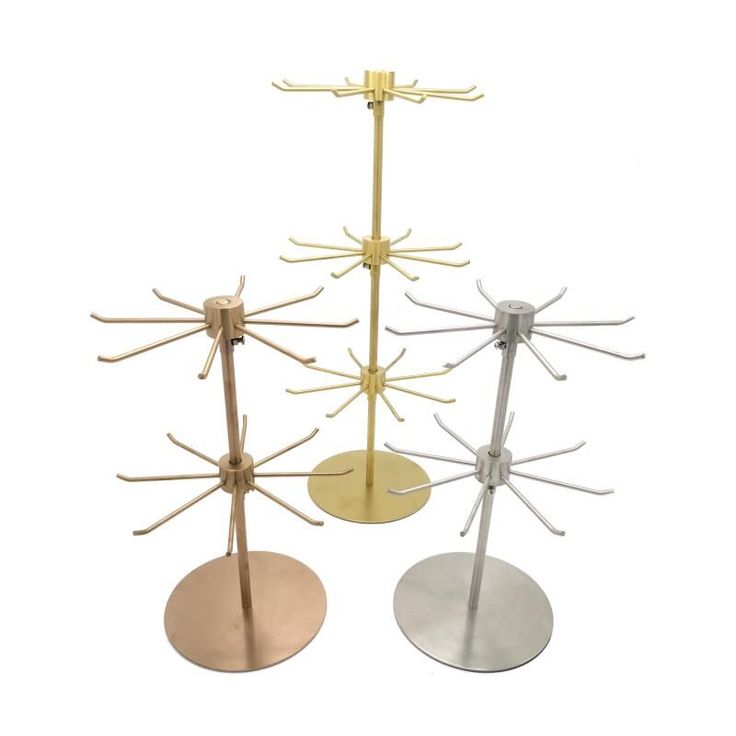 three metal racks with different colors and designs on each one, the stands are holding four circular discs