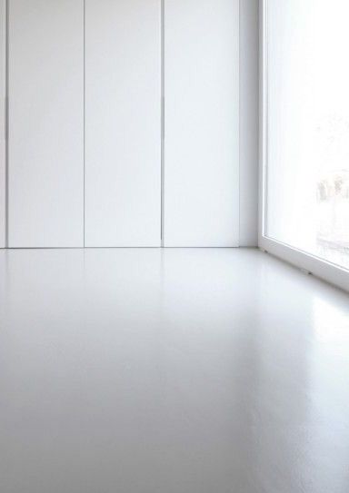 an empty room with white walls and floor