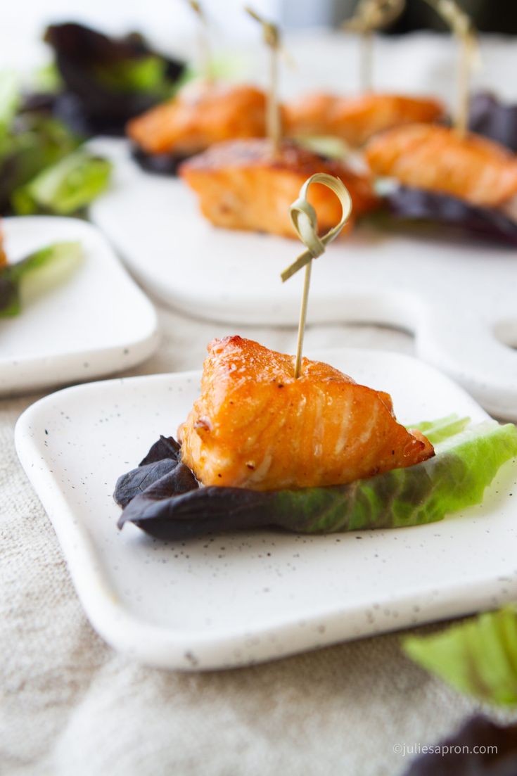 several small white plates with food on them