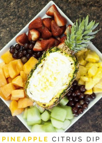 pineapple, grapes, strawberries and other fruit are arranged in a square plate