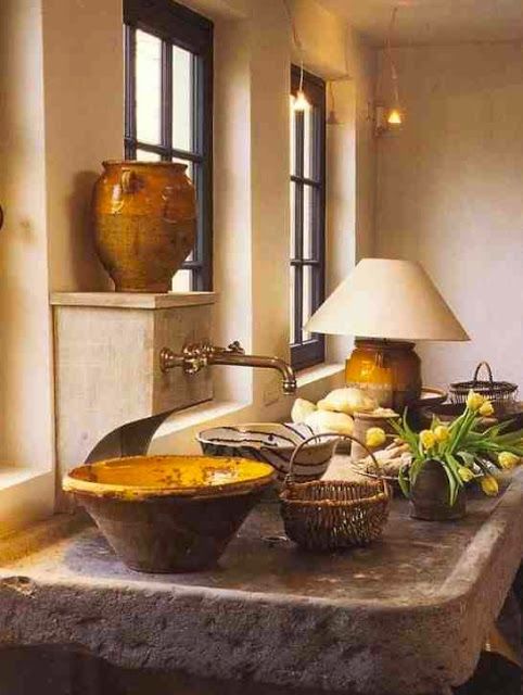 a kitchen counter with bowls on it next to a lamp