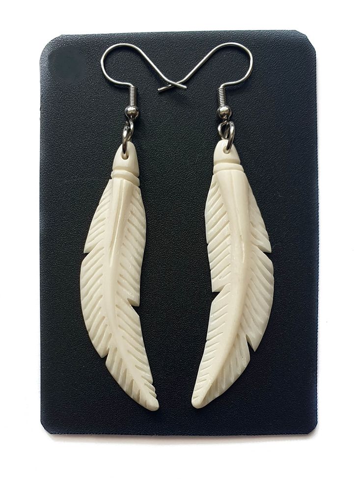 PRICES MAY VARY. These Bone Earrings feature a beautiful bone feather hand carved out of ox bone wonderful detail. Unique! Earrings Material: Ox Bone Earring Length (with Hook): 2.4 inch (60mm) Earring Size: 1.6 x 0.4 inch (40mm x 10mm) Hook Type: French Hook These Bone Earrings feature a beautiful bone feather hand carved out of ox bone wonderful detail. Unique! Animal Bone Jewelry, Witchy Business, Deer Antler Jewelry, Feather Fashion, Antler Jewelry, Bone Earrings, Bone Jewelry, Earrings Handmade Dangle, Carved Bone