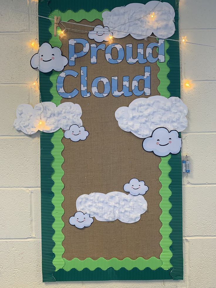 a bulletin board that says proud cloud with sheep on it and lights strung from the wall