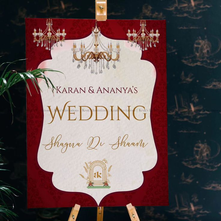 a red and white wedding sign sitting on top of a wooden easel next to a potted plant