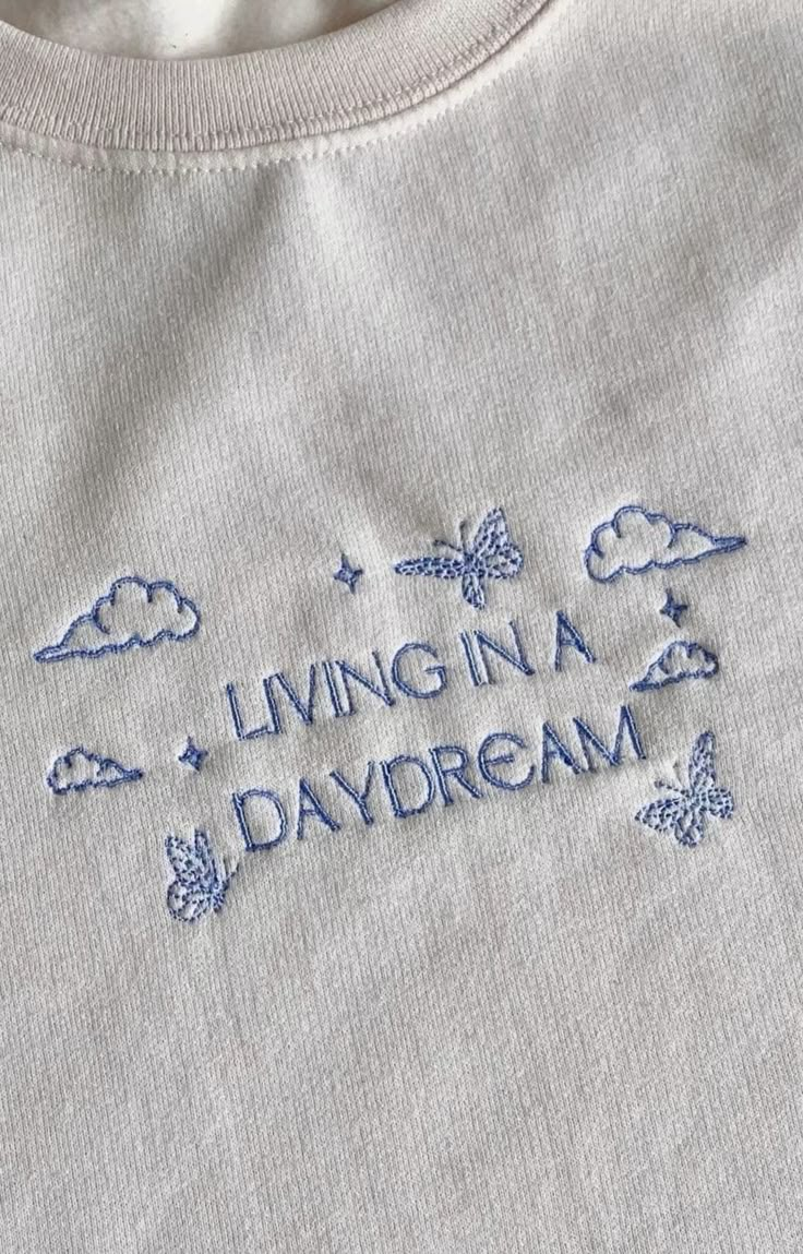 a t - shirt with the words living in a daydream embroidered on it