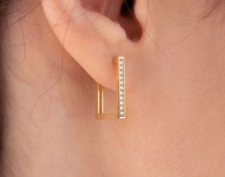 Our rectangle hoop earring is 14k solid gold and its one side is decorated with zircon stones that look charming. It will accompany you every day and everywhere with its minimalist and dainty style. If you think of it as a gift, you can make happy your loved ones on mother's day, birthdays, valentine's day, anniversaries, or graduations. It will be a perfect gift. Its inner diameter is approx. 9.90 mm and the outer diameter is approx. 13.28 mm. 🎁 If you want you can add a gift note for your lov Modern Rectangular Hoop Earrings For Anniversary, Rectangular Yellow Gold Huggie Earrings Minimalist Style, Minimalist Yellow Gold Rectangular Huggie Earrings, Minimalist Rectangular Huggie Earrings Gift, Rectangular 14k Gold Huggie Earrings As Gift, Minimalist 14k Gold Rectangular Hoop Earrings, Rectangle Hoop Earrings, Earring Minimalist, Minimalist Earring