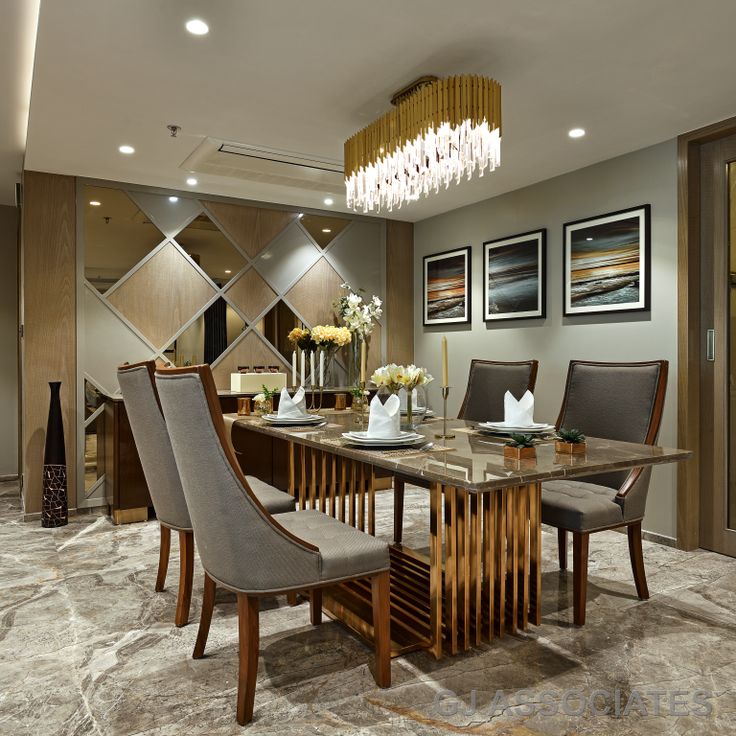 a dining room table with chairs and chandelier in the middle, surrounded by pictures on the wall