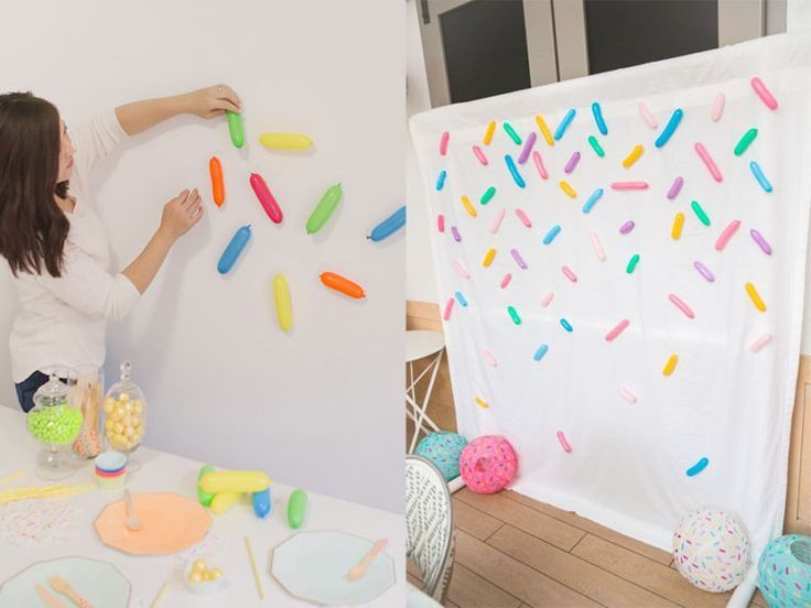 a woman is decorating a wall with sprinkles