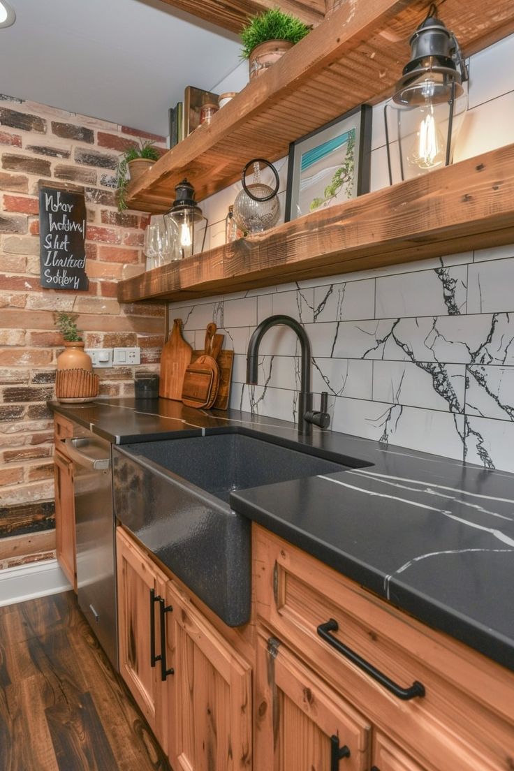 a kitchen with wooden cabinets and black counter tops next to a brick wall that has hanging lights above it