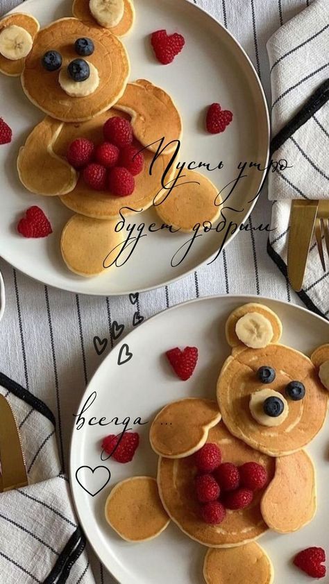 two white plates topped with pancakes covered in fruit and teddy bear face toppings next to each other