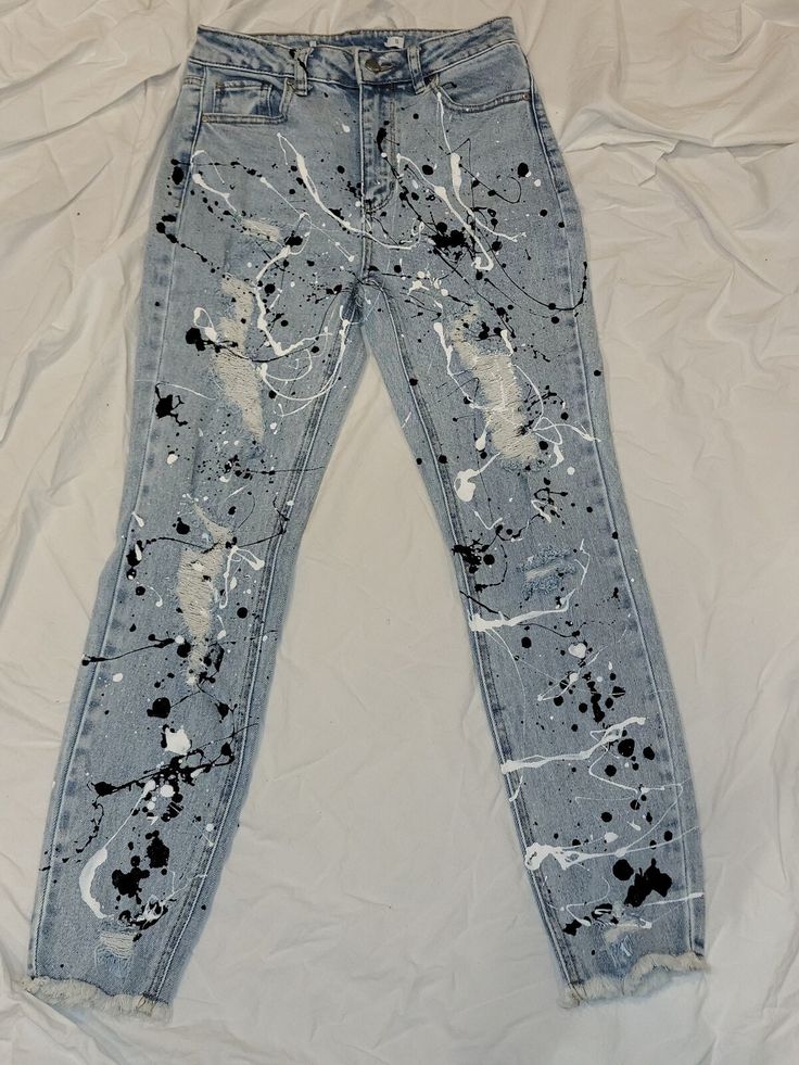 an old pair of jeans with paint splattered all over them