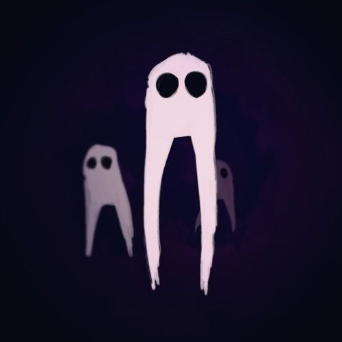 two white scissors are standing next to each other on a dark background with black eyes