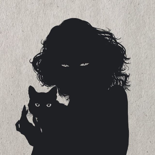 the silhouette of a person holding a cat in front of a white wall with black writing on it