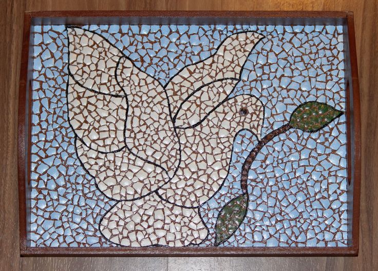 a mosaic tile with a bird on it's back and a branch in the middle