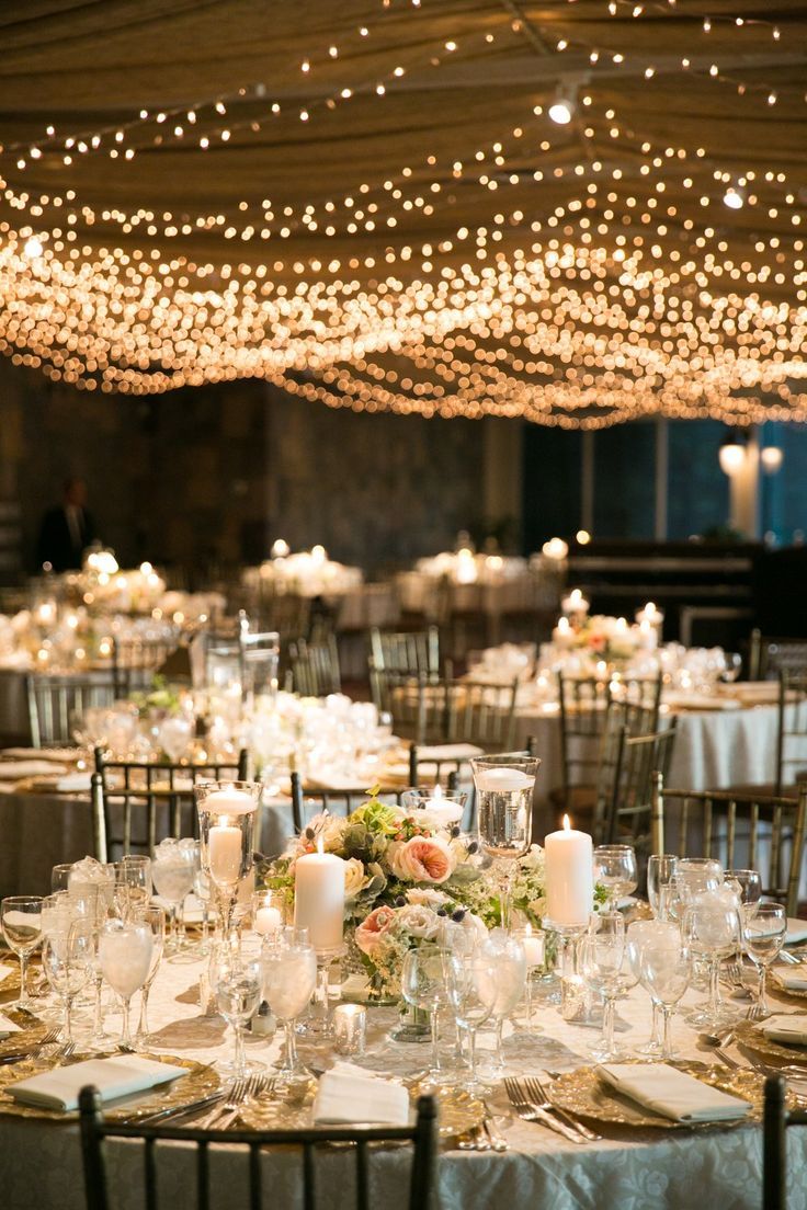 the tables are set up with candles and place settings for an elegant dinner or reception