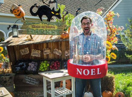 a man in a bubble ball costume with pumpkins and other decorations