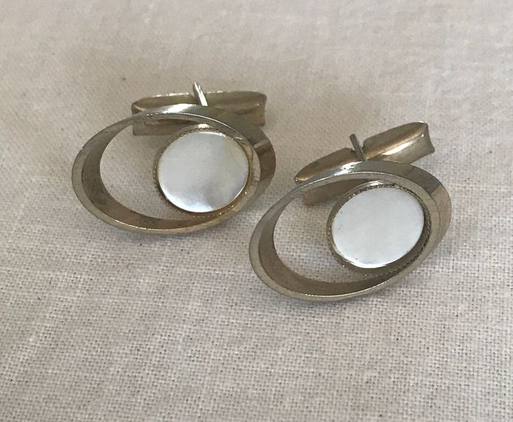 Silver tone cuff links with mother of pearl in the center. Tie Tack, Tie Accessories, Cuff Links, Silver Pearls, Tie Clip, Mother Of Pearl, Cufflinks, Silver Tone, Cuff