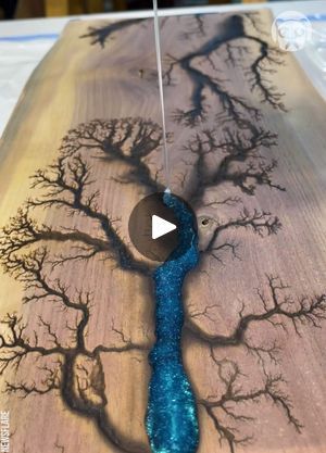 an image of a tree with blue water in the center on a wooden table top