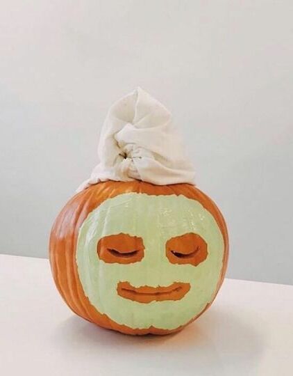 a pumpkin with a face painted on it