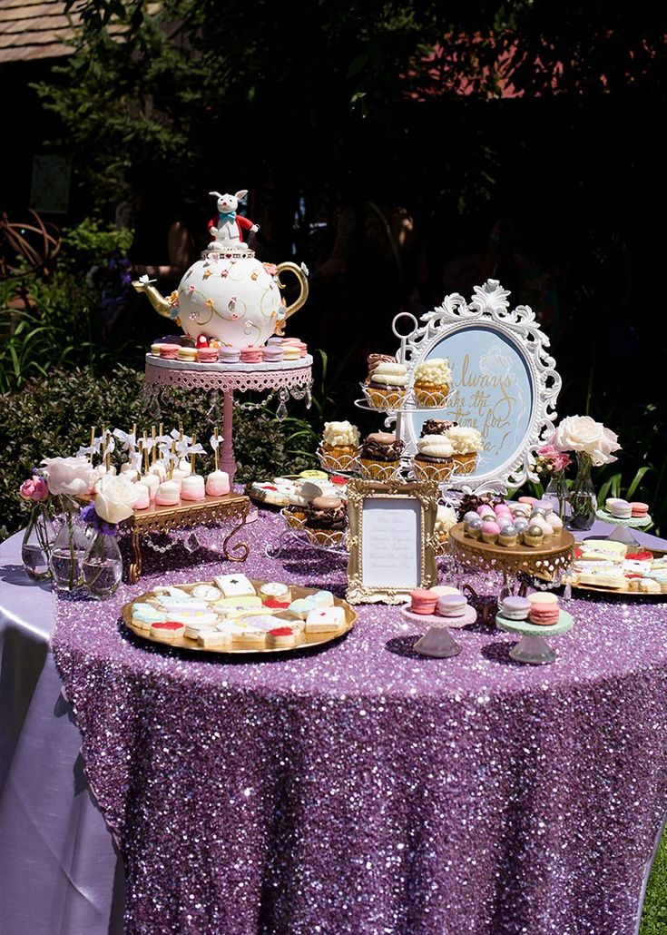 a purple table topped with lots of desserts