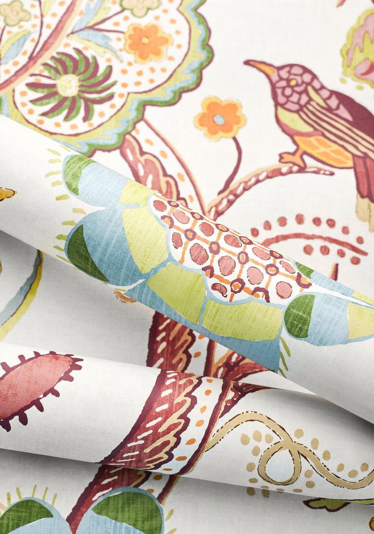 a close up view of a colorful wallpaper with birds and flowers