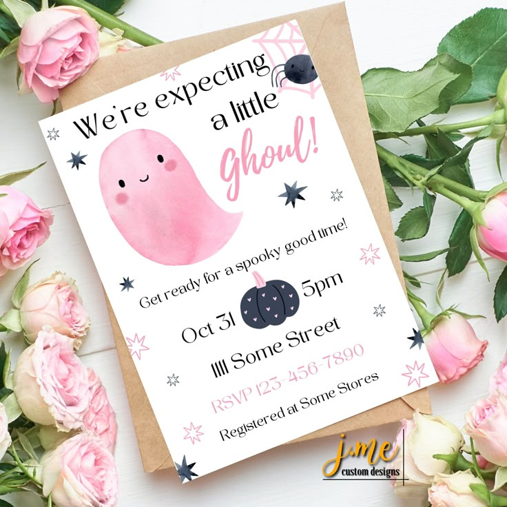 there is a card with a pink ghost on it next to roses and flowers in the background