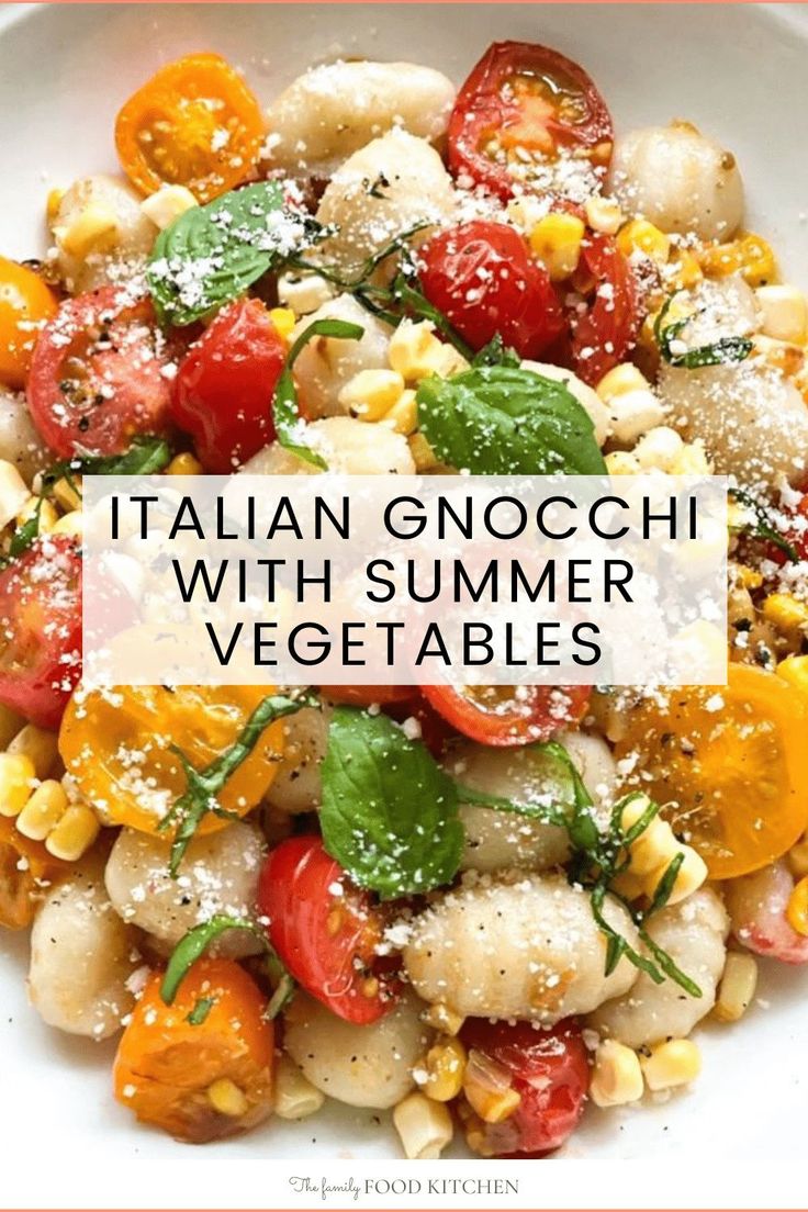 italian gnocchini with summer vegetables in a white bowl topped with sprinkled parmesan cheese