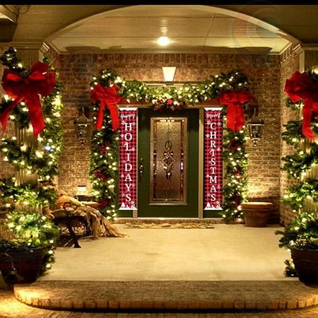 christmas decorations on the front door of a house with lights and wreaths around it