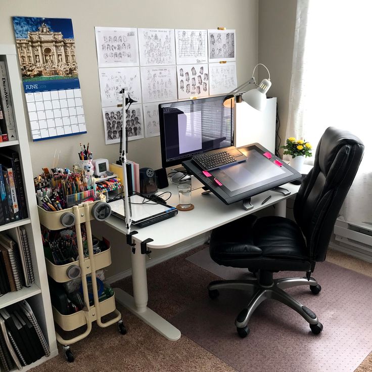 a desk with a laptop computer on top of it next to a book shelf filled with books