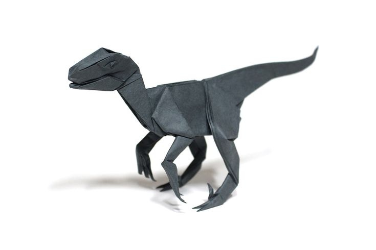 an origami dinosaur is shown on a white background