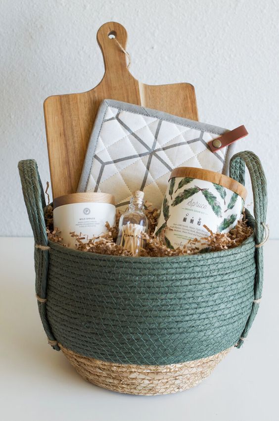 a basket filled with personal care items on top of a white table next to a cutting board