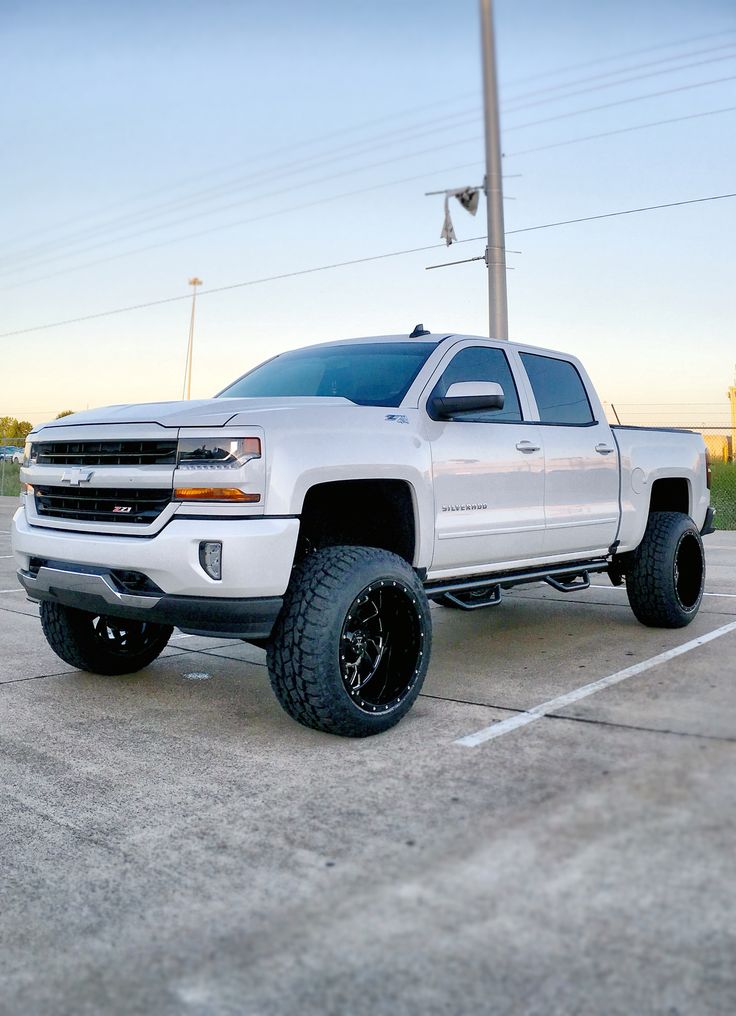 a white truck parked in a parking lot