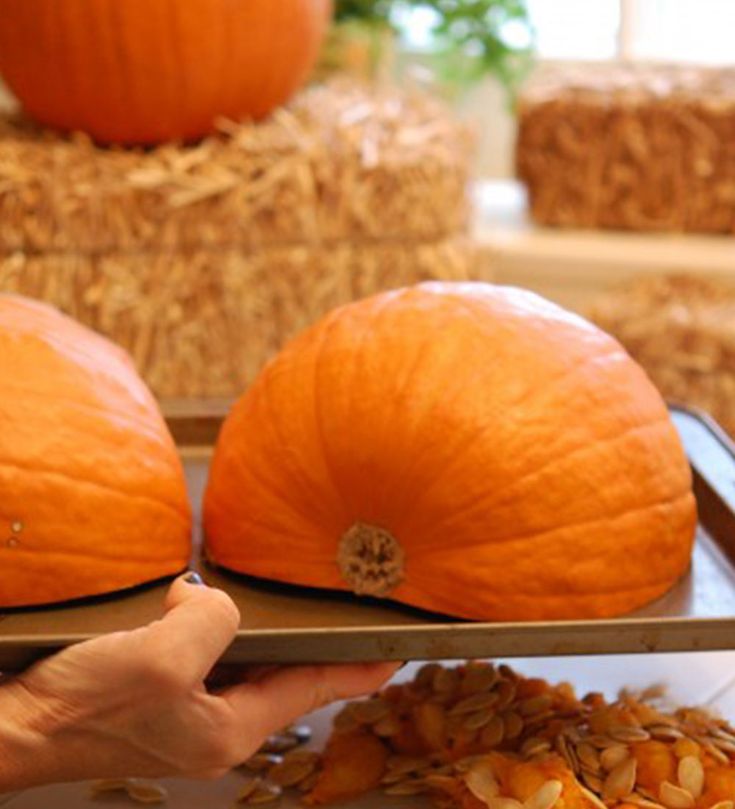 two pumpkins sitting on top of a metal tray