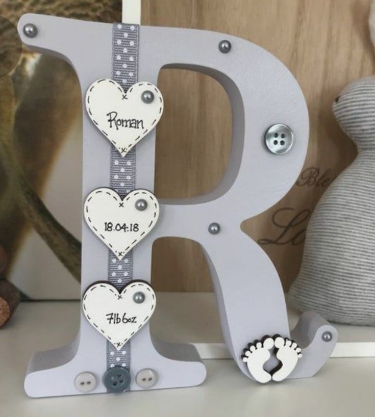 the letter r is decorated with hearts and paw prints for a baby's first birthday