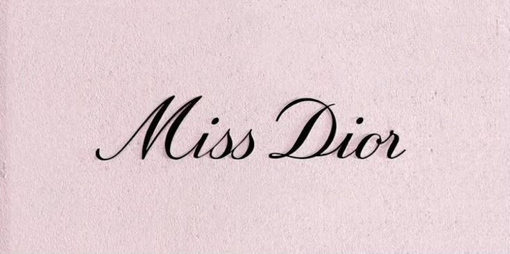 the word miss dior written in cursive writing on a pink paper background