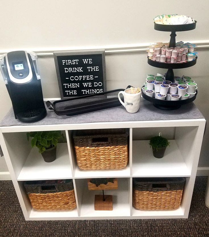 a coffee bar with drinks and snacks on it's side shelf, along with a sign that says first we drink the same thing then we do the things