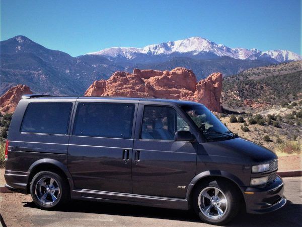 a van is parked in front of some mountains