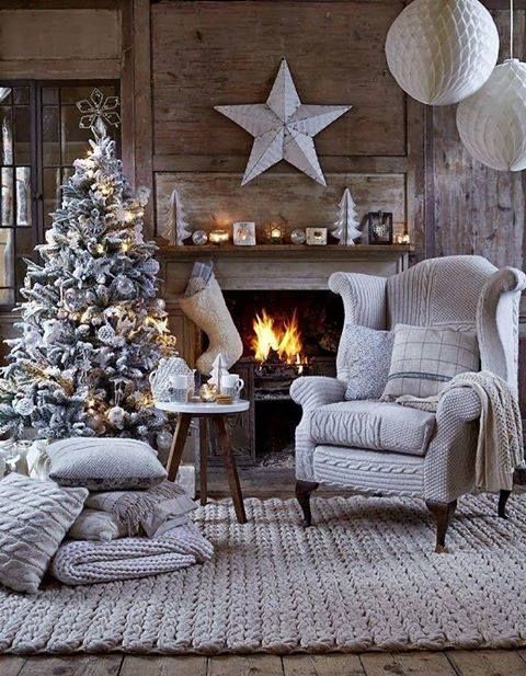 a living room filled with furniture and a christmas tree in front of a fire place