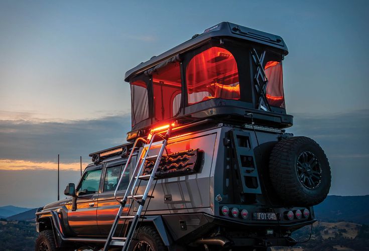 a truck with a ladder up to it's roof